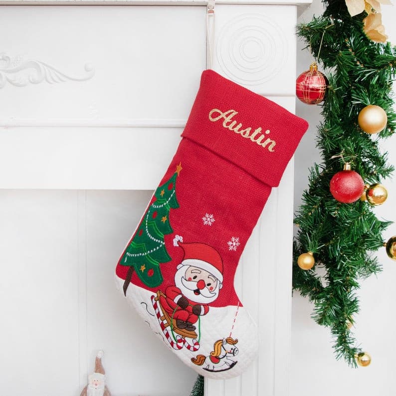 This santa Christmas stocking is made of cotton and burlap with a cartoon applique pattern. This would be a beautiful ornament wherever you hang your stockings, also would be a great gift for your family and friends. 