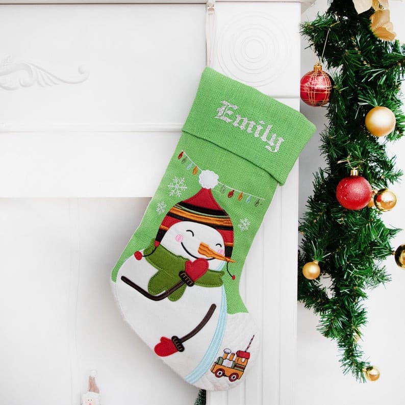 This snowman Christmas stocking is made of cotton and burlap with a cartoon applique pattern. This would be a beautiful ornament wherever you hang your stockings, also would be a great gift for your family and friends. 
